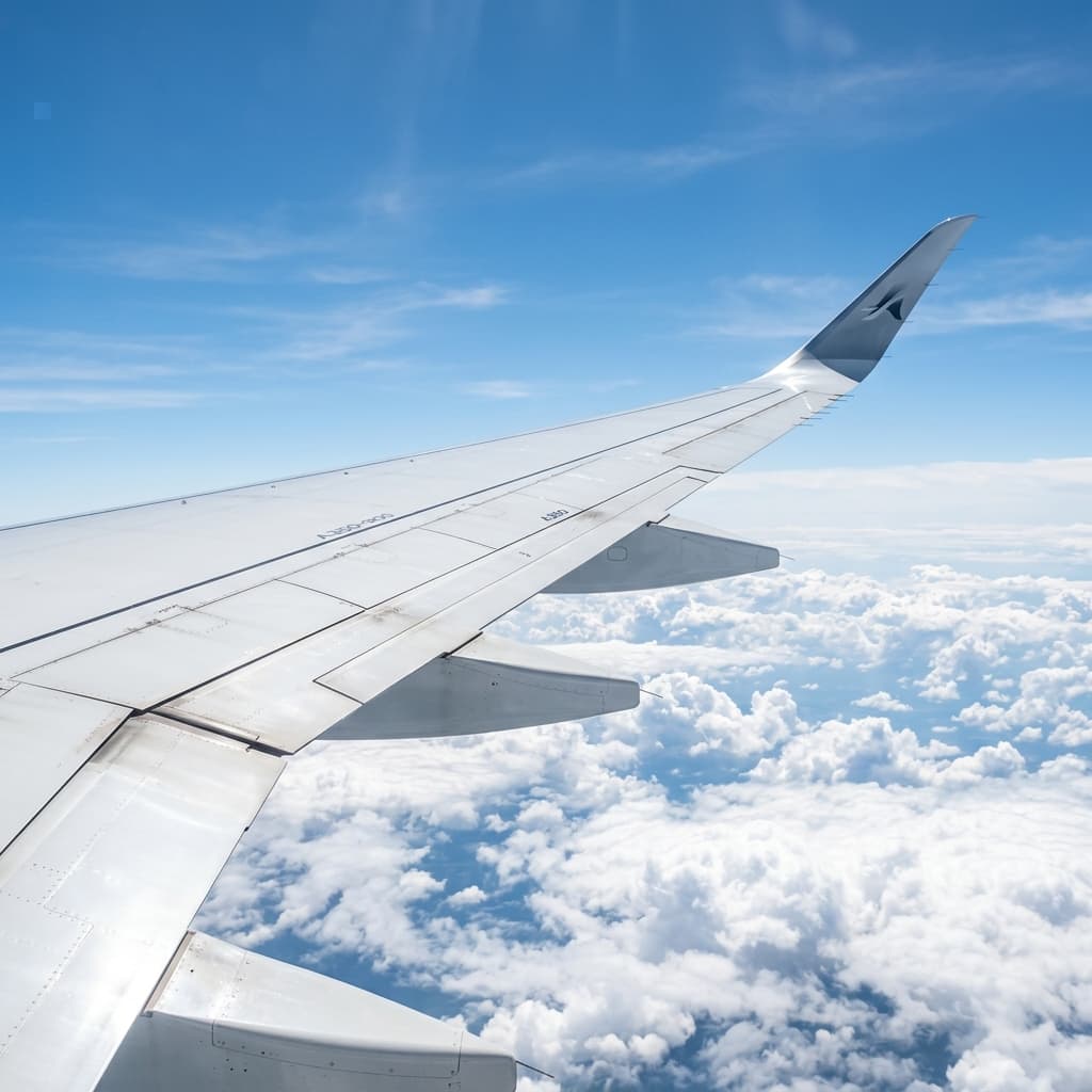 Airplane wing over clouds